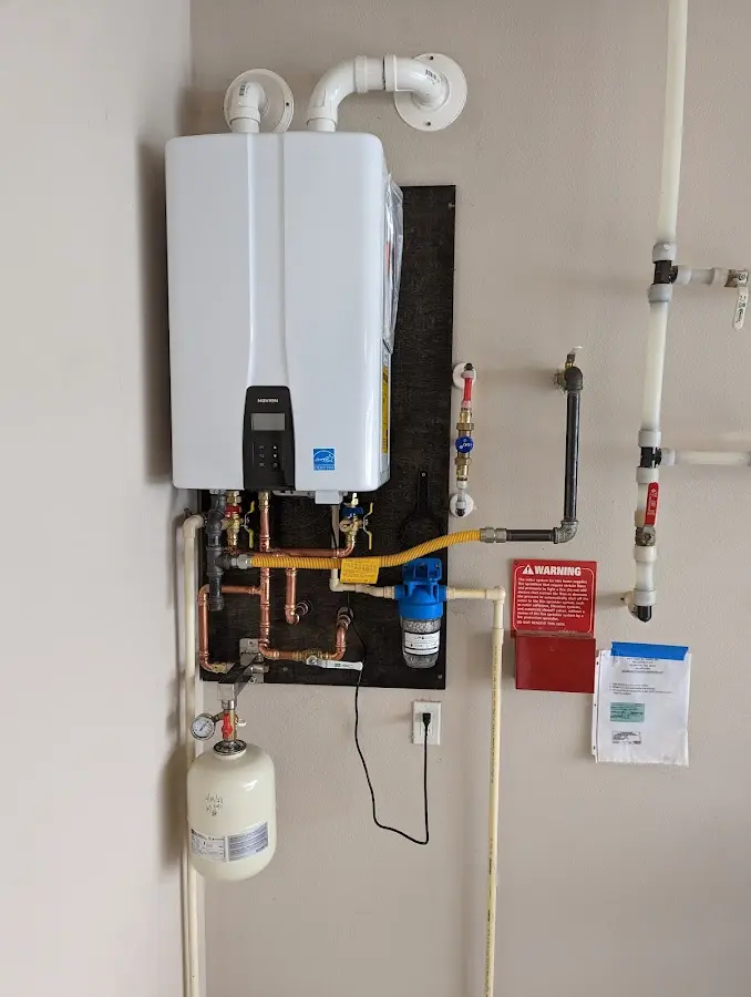 Professional plumber installing copper piping in a Lehi home